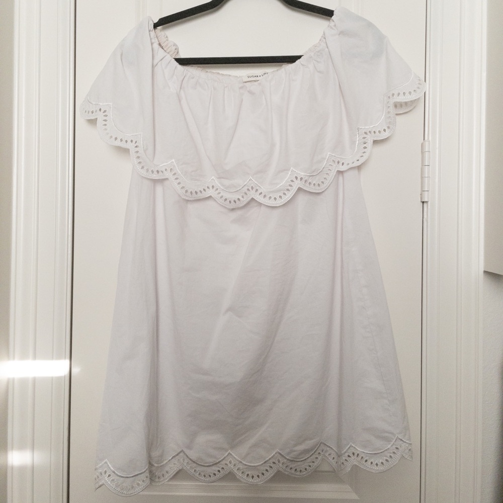 White lace detail off the should dress